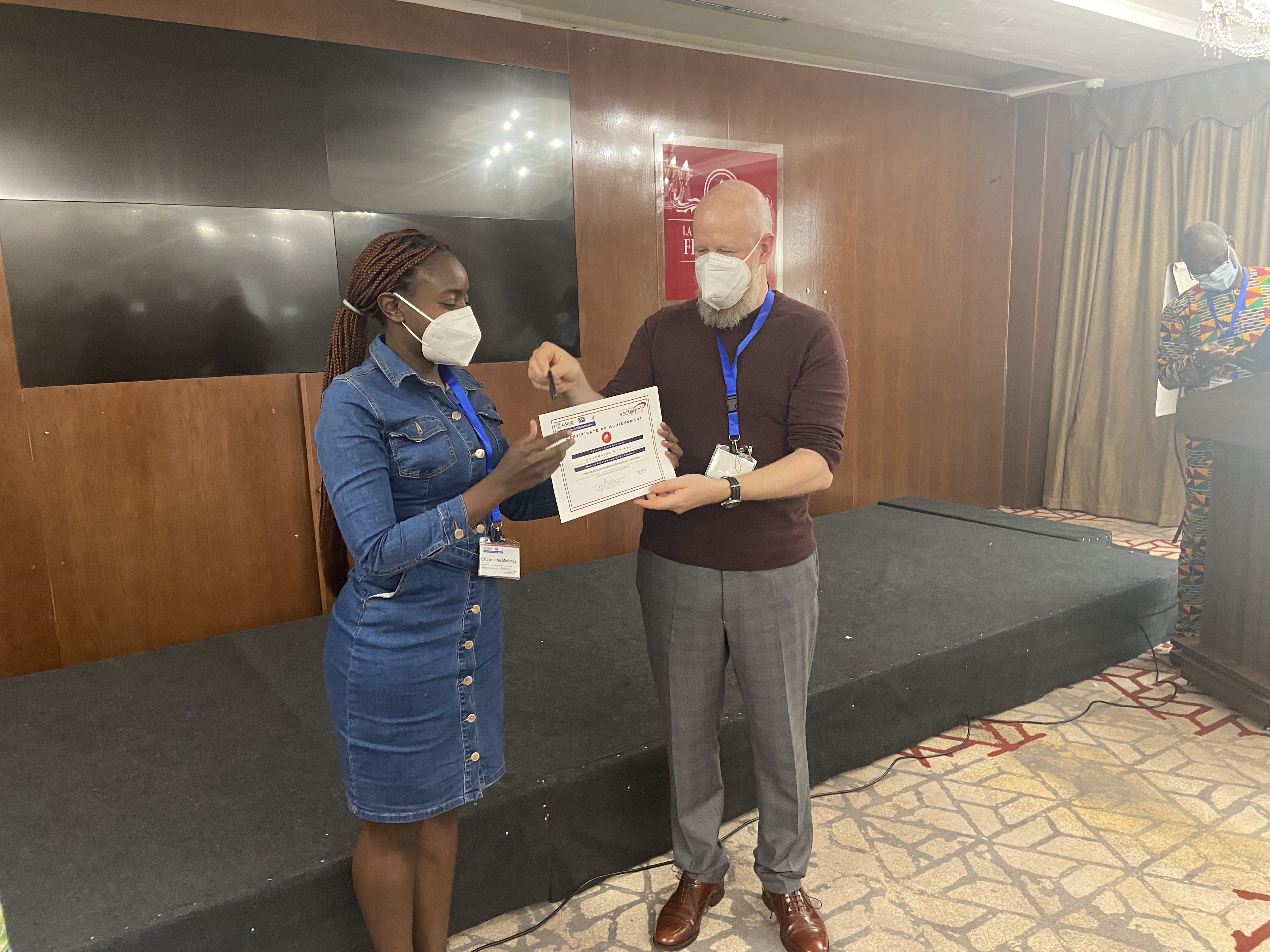 Charmaine Matimba receiving a certificate of achievement from PMI VectorLink Technical Director Dr. Matthew Kirby in Dakar, Senegal. 